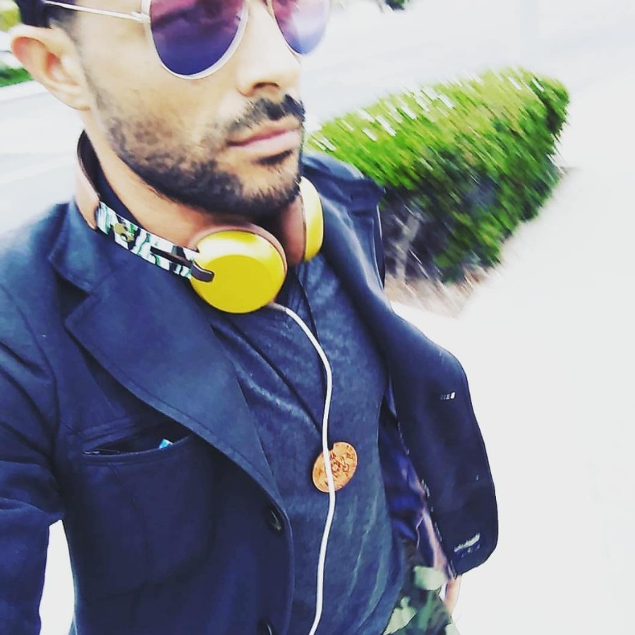 Sparks wearing yellow headphones outdoors, wind in the trees